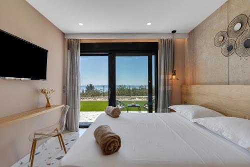 a bedroom with a large white bed and a large window at Villa Teraco in Makarska