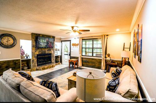 a living room with a couch and a fireplace at Dollys Retreat in Pigeon Forge