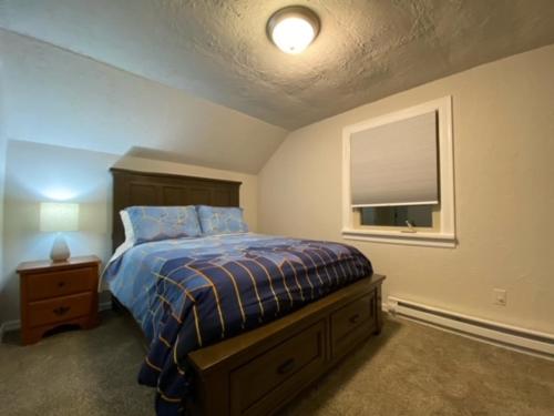 a bedroom with a bed and a window at Charming Brick Home with bonus space & foosball in Spokane