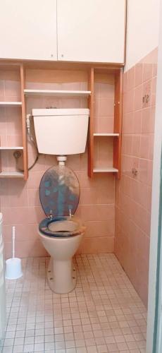 a bathroom with a toilet with a blue seat at Standard Apartment 5P TH in Vienna