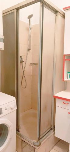 a shower with a glass door in a bathroom at Standard Apartment 5P TH in Vienna