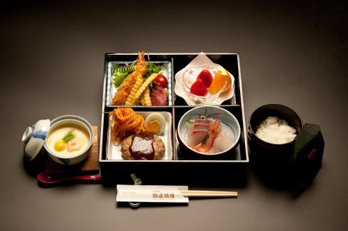 a tray of food with chopsticks and bowls of food at Jizokan Matsuya Ryokan in Nagano