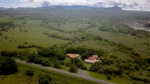 an aerial view of a house in a field with a road at Hotel El Cocobolo Food&Rest Room 1 B&B WiFi AC Pkg Free Swimmingpool in Ahogados