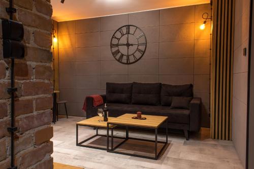 a living room with a couch and a table at Apartament Black Loft in Nysa