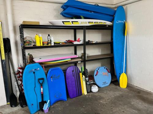 a room with a shelf with surfboards on it at Denhams Beach side holiday apartment in Batemans Bay