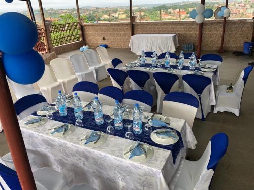 a set of tables and chairs with water bottles on them at Home Away From Home in Yaoundé