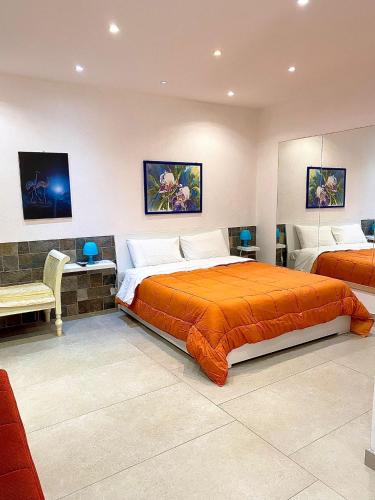 a large bedroom with two beds and a couch at La Magione in Palermo