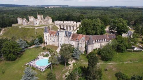 an aerial view of an old castle with a swimming pool at La Courmonière in Courmont