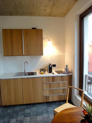 a kitchen with wooden cabinets and a sink at Cologne Country Lodge in Cologne