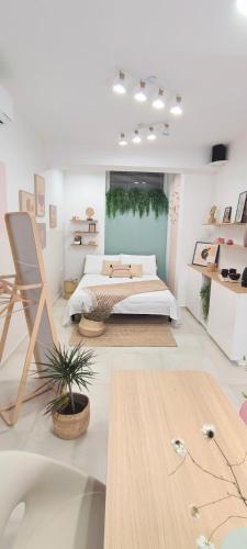 a white bedroom with a bed and a table at Cozy Rooms Luna - Home Gym in Zadar