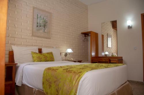Postel nebo postele na pokoji v ubytování Hotel Mac Arthur