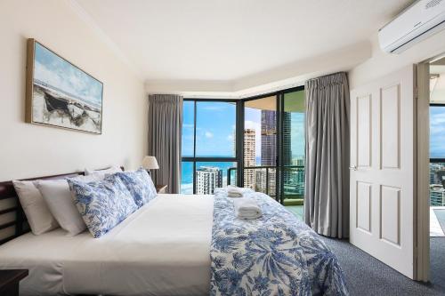 a bedroom with a bed and a large window at Sun City Resort managed by Gchs in Gold Coast