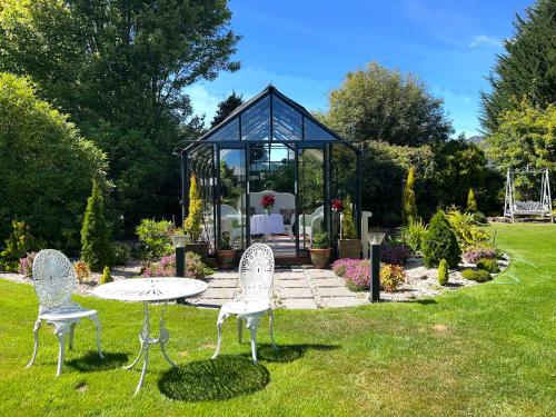 a gazebo with a table and chairs in a yard at Highgrove in Promised Land