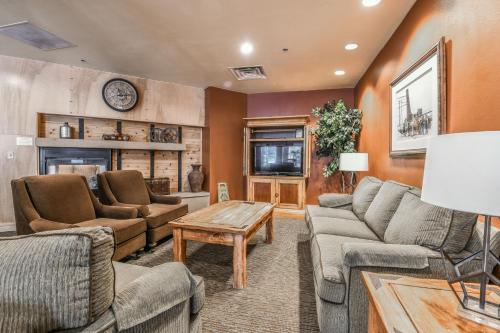 a living room with couches and a fireplace at Silver Mill 8154 in Keystone