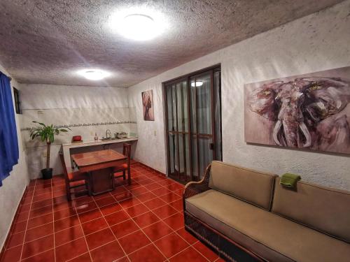 a living room with a couch and a table at Estancia Flores1 in Tepoztlán