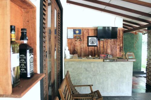 a kitchen with a sink and a counter with a bottle of wine at Green Cottage in Anuradhapura