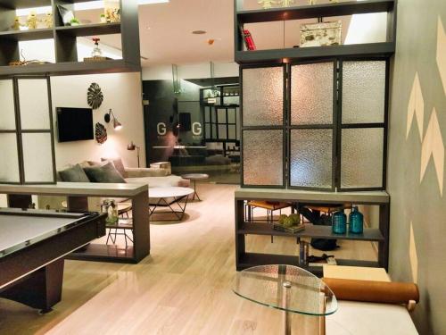 a living room with a pool table and a living room at Beautiful Hi-rise, King size, HS Wi-Fi, pool, gym in Mexico City