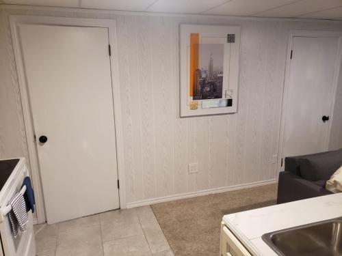 a living room with a couch and a picture on the wall at 2plex, Choose, 1of 2 entire units apparts in Hamilton
