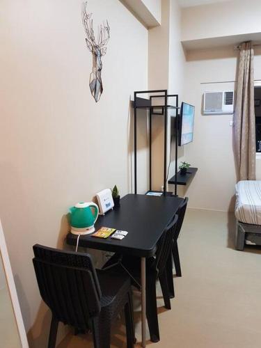 a black table and chairs in a room at Keys N Places @ Avida Aspira in Cagayan de Oro