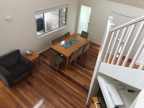 a dining room with a table and a chair at Beachbreak Boomerang in Boomerang Beach