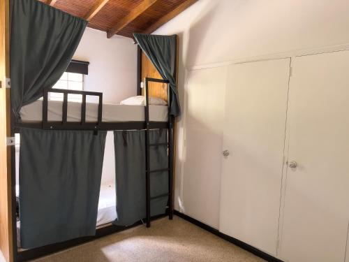 a bedroom with a bunk bed and a closet at Rock Hostel Medellin in Medellín