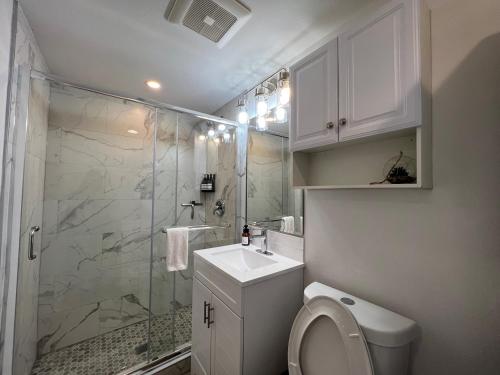 a bathroom with a shower and a toilet and a sink at Perfect Workation Spot, Fast Wi-Fi, Fully Stocked in Seattle
