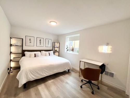 a bedroom with a bed and a desk and a chair at Perfect Workation Spot, Fast Wi-Fi, Fully Stocked in Seattle