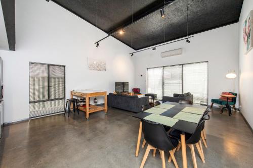 a living room with a table and a couch at Vasse NewYorker Townhouse in Vasse