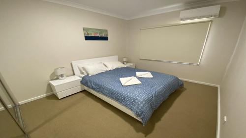 a bedroom with a bed with two towels on it at Unit 48 Seafront Estate in Jurien Bay
