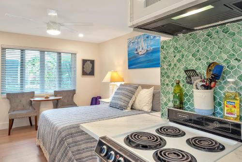 a bedroom with a bed and a stove top oven at Art Deco Pool house mile and a half to beach Pets Welcome in Lake Worth