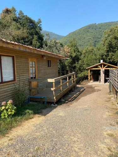 a log cabin with a ramp leading to a building at Cabañas Lihuén SPA in Parral