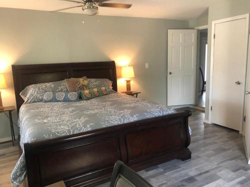 a bedroom with a large bed with a ceiling fan at Holiday Hideaway in Rockport