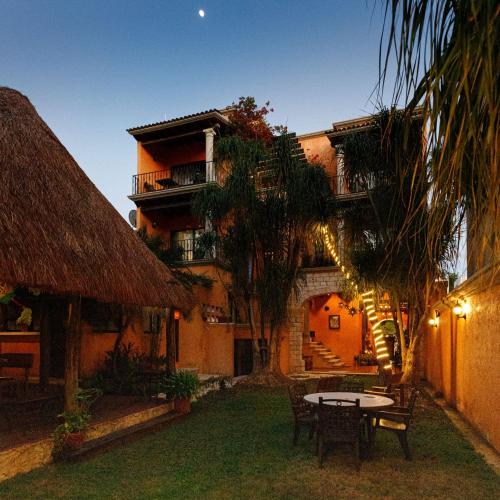 a house with a table and chairs in front of it at Hotel Lunata - 5th Avenue in Playa del Carmen