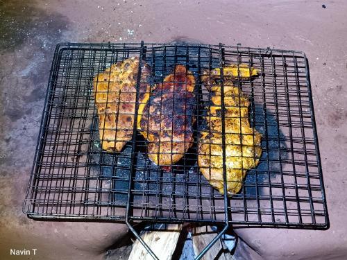 a grill with several different types of food on it at Tathagata Farm in Darjeeling