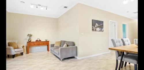 a living room with two chairs and a table at Ensuite Private bath toilet City Airport in Truganina