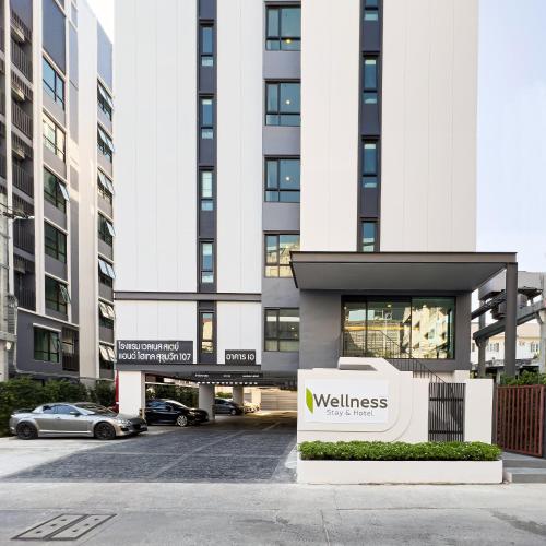 a building with a wellness sign in front of it at Wellness Stay & Hotel Sukhumvit 107 in Bangna