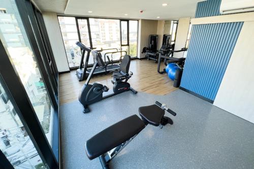 a gym with cardio equipment in a building at Wellness Stay & Hotel Sukhumvit 107 in Bangna