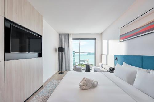 a hotel room with a bed and a television at December Hotel in Nha Trang
