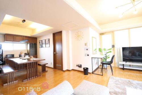 ein Wohnzimmer mit einer Küche und einem Esszimmer in der Unterkunft NK BLD7F Sapporo 3LDK 3BR 1 floor 1 room in Sapporo