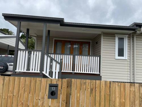 a house with a fence in front of it at 13 Cypress Lane in Woorim