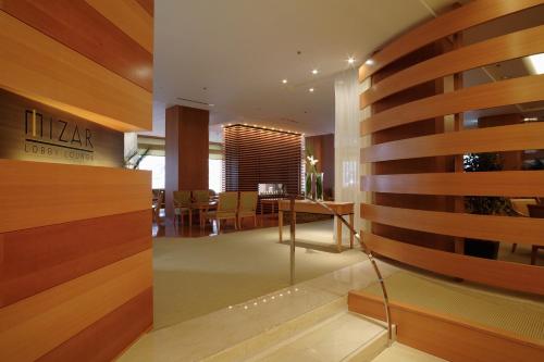 a lobby with a table and a dining room at Sapporo Grand Hotel in Sapporo