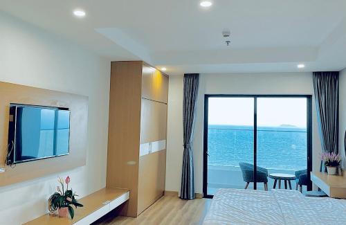 a bedroom with a bed and a view of the ocean at TMS HONG MY QUY NHON BEACH in Quy Nhon