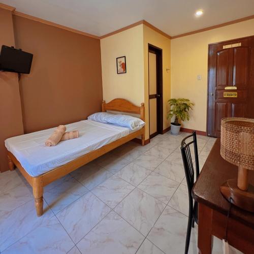 Ένα ή περισσότερα κρεβάτια σε δωμάτιο στο Balayong Pension