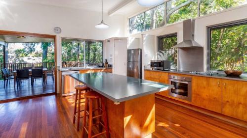 a kitchen with a large island with a counter top at Decked out for a Fantastic Holiday - Winnett St, Woorim (Upstairs only) in Woorim