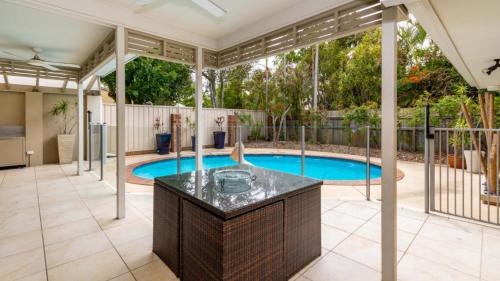 a swimming pool in a house with a patio and a swimming pool at Stunning Waterfront Home with pool - Sylvan Beach Esp, Bellara in Bellara