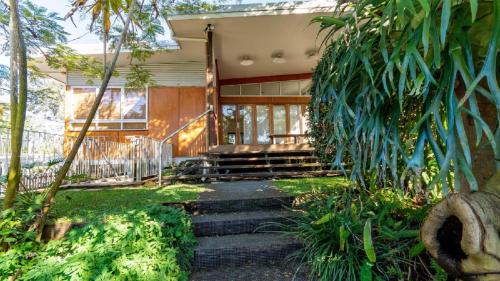 a house with stairs leading to the front entrance at Decked out for a Fantastic Holiday - (Whole house) Winnett St, Woorim in Woorim