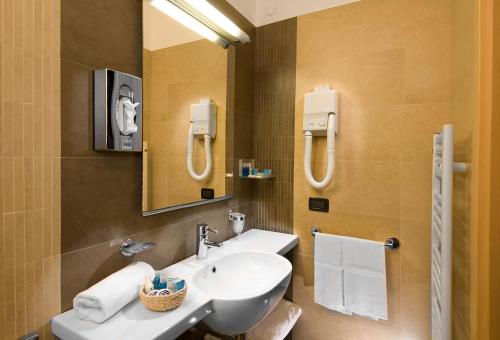 a bathroom with a sink and a mirror at Hotel Imperial in San Benedetto del Tronto