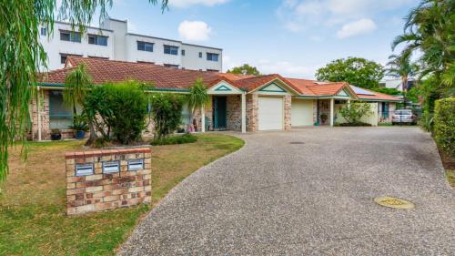 a house with a driveway in front of it at Delightful Duplex on Rose Ct, Bongaree in Bongaree