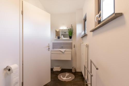 małą łazienkę z toaletą i umywalką w obiekcie Großer Plöner See, Terrasse, Garten, Grill, Garage w mieście Plön