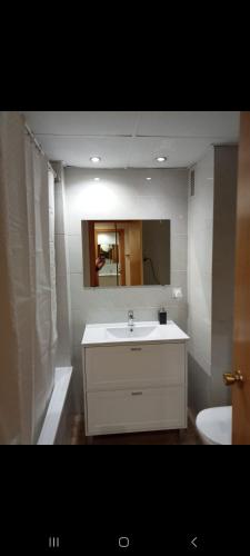a bathroom with a white sink and a mirror at A ESTRENAR PRECIOSOS APARTAMENTOS APARTHOTEL INTER2, NEW APARTMENTS lN APARTHOTEL 12 months open! self check in! RESERVA Garaje! in Salou